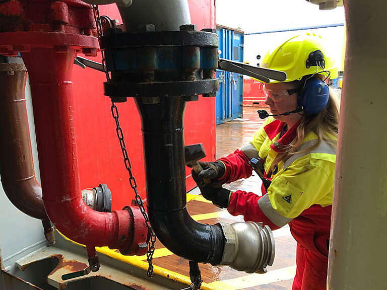 Island Offshore woman working on pipes
